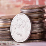 coin ruble on the background of banknotes closeup